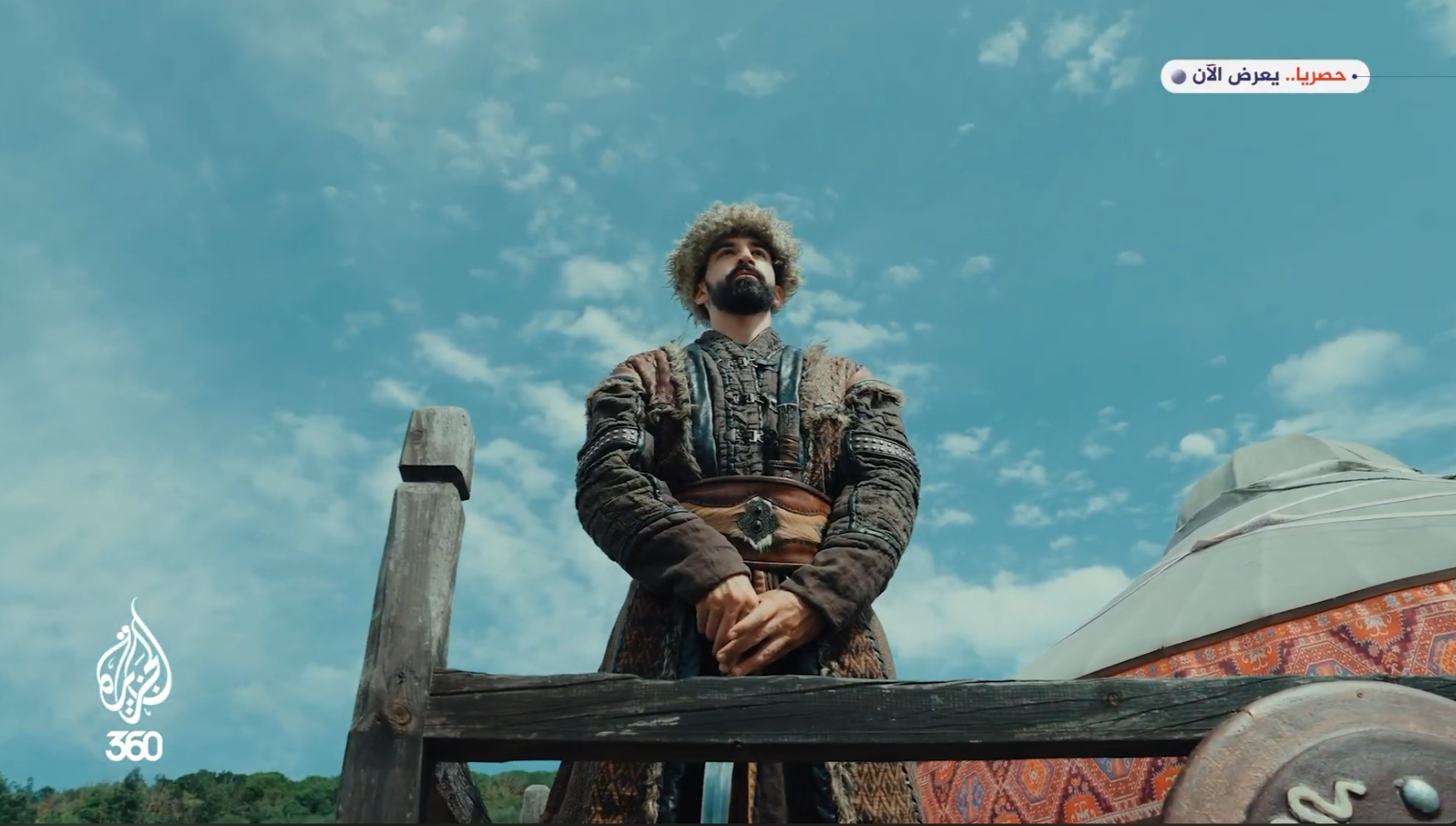 Miras: a character in period costume beneath a blue sky, beside a traditional tent