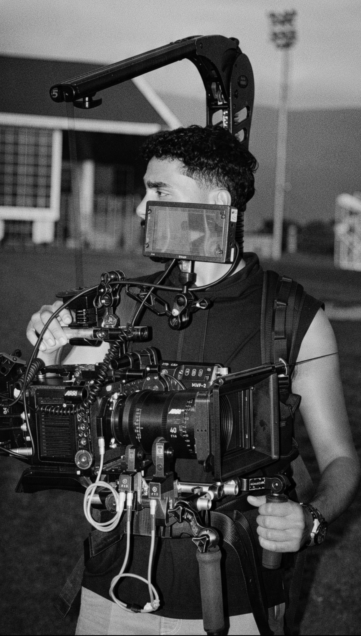Ziyad Ahmad with a cinema camera on set, in black and white